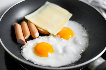 Cooking of the breakfast / eggs. Eggs on the frying pan 