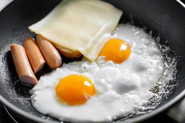 Cooking of the breakfast / eggs. Eggs on the frying pan 