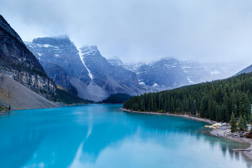 Fototapeta na wymiar Cold and Foggy Moraine Lake at Banff National Park