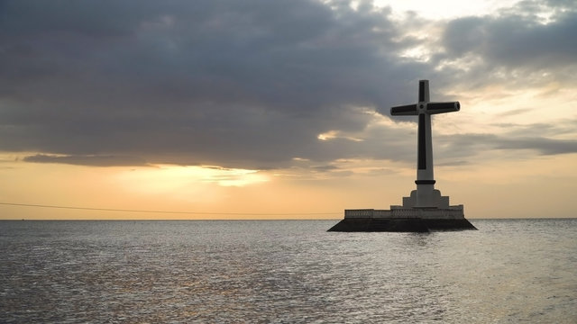 Sunken Cemetery cross in Camiguin Island, Philippines. Large crucafix marking the underwater sunken cemetary of the coast of camiguin island near mindanao in the Philippines. Catholic cross in the