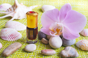 Arab massage oil. Stones and Orchid flower with natural oil in the Spa salon.
