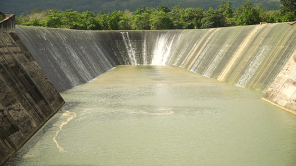 Dam on the lake in the rainforest on the island. Water flowing from the dam, Water for Irrigation countryside. Water Cascades Over Lake Bohol island, Philippines. .