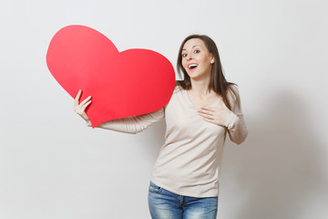 Pretty fun young smiling woman holding big red heart in hands isolated on white background. Copy space for advertisement. With place for text. St. Valentine's Day or International Women's Day concept.