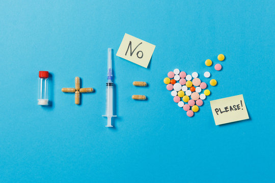 Pills bottle plus syringe needle equals medication colorful round tablets in form of heart isolated on blue background. Paper sticker sheet text No please. Treatment, choice, healthy lifestyle concept - Powered by Adobe
