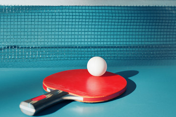 Red racket and a ball for table tennis