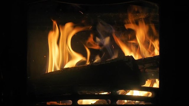 Fire in a fireplace. Burn fire with wood and legs indoor home