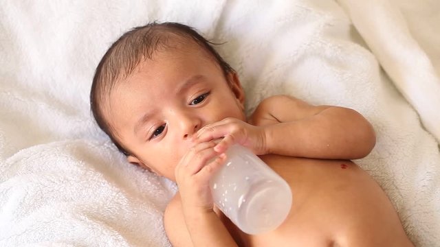 Baby feeding from a bottle 
