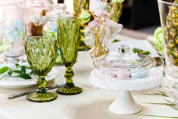 Festive table, decorated with vases, fruits and pastries.
