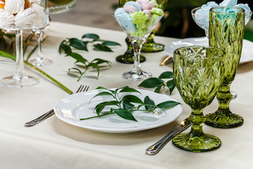 Festive table, decorated with vases, fruits and pastries.