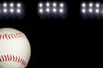 Classic Baseball on a Field with Stadium Lights in the Background