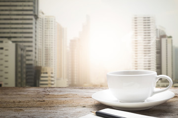 Blurred background of sunset city and desk space.