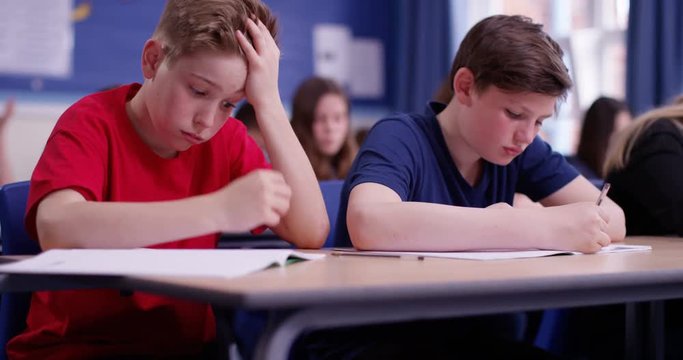 4k, Overworked young student sitting with his head in his hands. Slow motion.