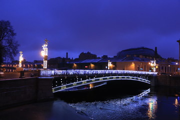 Fototapeta na wymiar Russia, St. Petersburg, Panteleimon bridge in the evening with reflection in water