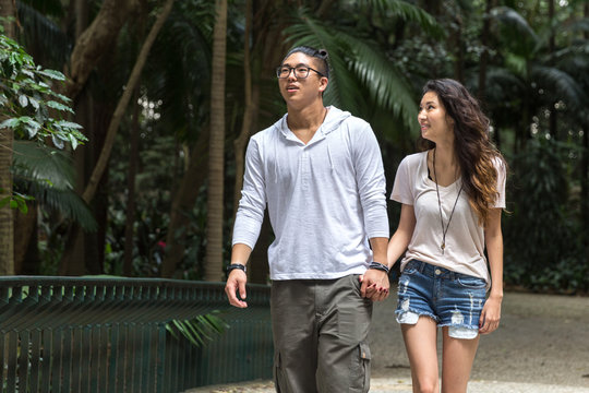 Asian Couple Walking In The Park