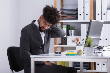Businessman Suffering From Neck Pain
