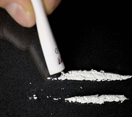 drug use, people, addiction and substance abuse concept. Rolled banknote, two lines cocaine on...