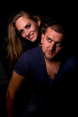 The guy and the girl pose in the studio