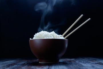 hot rice in brown bowl with chopsticks in japanese style