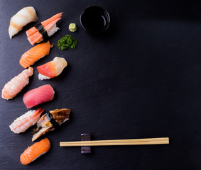 Set of sushi sashimi on stone table. Top view with copy space.