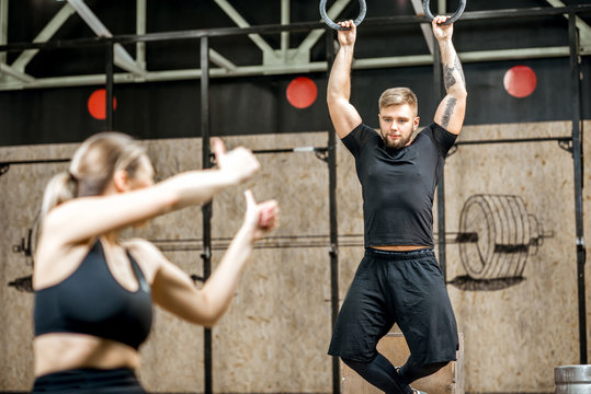 Young athletic couple training in the crossfit gym