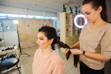 Beautiful woman getting haircut by hairdresser in the beauty salon.