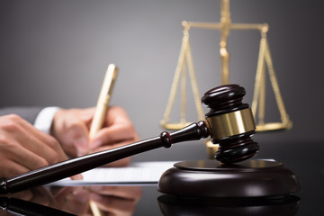 Close-up Of A Gavel On Sounding Block