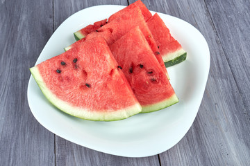 Chopped pieces of watermelon on a white plate