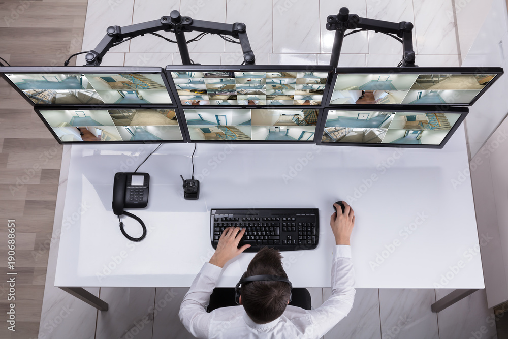 Aufkleber Security Guard Monitoring Multiple Camera Footage On Computer