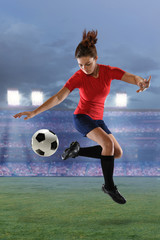 Naklejka premium Female Soccer Player in Action