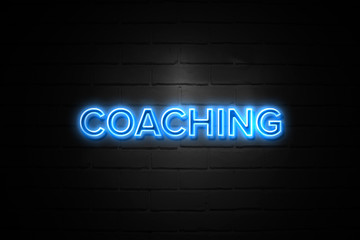 Coaching neon Sign on brickwall