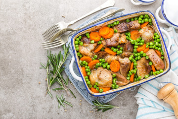 Meat baked with carrot and green peas