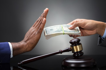 Close-up Of A Judge's Hand Refusing Bribe