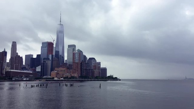 Scenic summer timelapse view of summer clouds moving across the skyscraper skyline of downtown Manhattan and the Hudson River in New York City