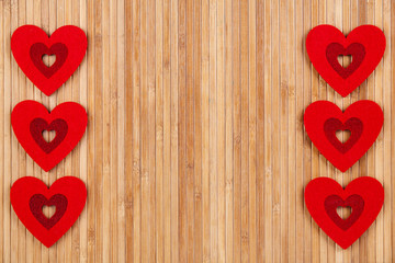 A lot of red hearts on a wooden background, a greeting card for Valentine's Day.