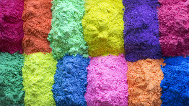 Festival of colors. Bright colors for holi festival. Many colorful holi paint background. Close up with copy space. Natural organic pigment.