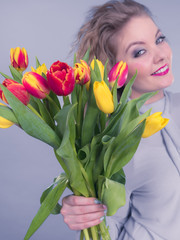 Pretty woman with red yellow tulips bunch
