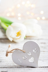 White wooden heart with tulips and lights