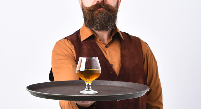 Waiter with whiskey or scotch on tray.