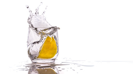 Splashing Lemon Slice Into A Glass Full With Water