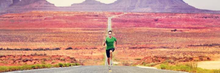 Runner man running sprinting on road of mountain nature. Male sprinter training for success. Fit...