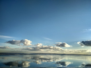 Fototapeta premium Reflections in the water on a sunny day at Wilhelmshaven Beach, Suedstrand