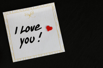 Valentine's Day - note 'i love you' with a heart - stone background
