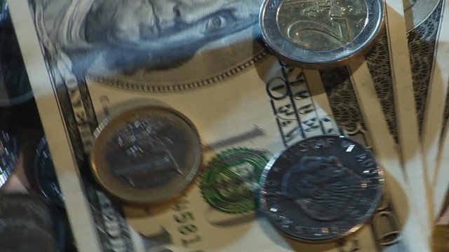 Money of different countries are circling around a close-up loop
