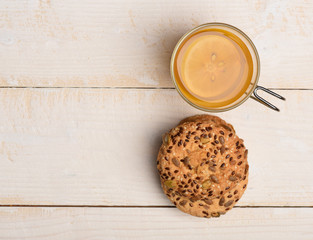 Biscuits with seeds placed near cup of tea. Oatmeal cookie