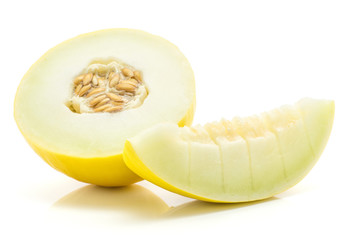 Yellow honeydew melon half and one slice cut into pieces isolated on white background.