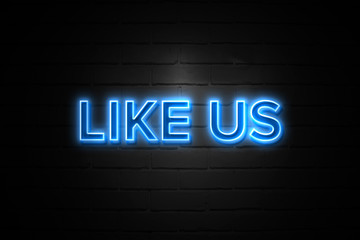 Obraz premium Like Us neon Sign on brickwall