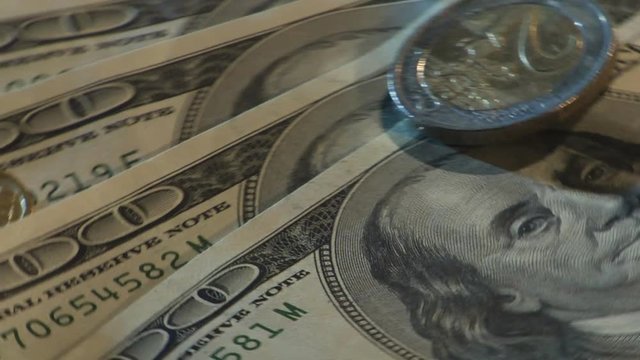 Money of different countries are circling around a close-up loop