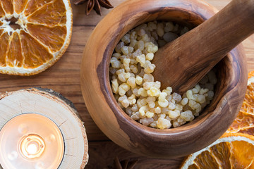 Fototapeta premium Frankincense resin in a mortar with a candle