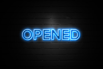 Opened neon Sign on brickwall