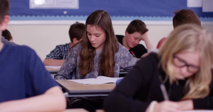 4k, School girl caught cheating using internet during her exam. Slow motion.